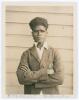 Edward &lsquo;Eddie&rsquo; Gilbert. Queensland 1930-1936. Original sepia candid-style photograph of Gilbert, standing three quarter length wearing cricket attire and Queensland blazer. 3.5&rdquo;x4.25&rdquo;. Photographer unknown. Name annotated in ink to lower margin. Good/ ver