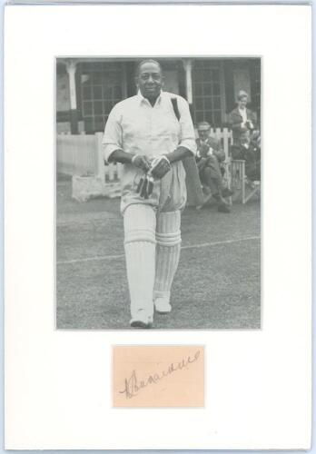 West Indies Test cricketers. Two mounted photographs, one a mono copy(?) photograph of Learie Constantine, the other a colour photograph of Brian Lara, each with signature in ink of the respective player window mounted below. Also a printed illustration o