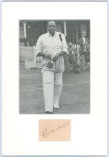 West Indies Test cricketers. Two mounted photographs, one a mono copy(?) photograph of Learie Constantine, the other a colour photograph of Brian Lara, each with signature in ink of the respective player window mounted below. Also a printed illustration o