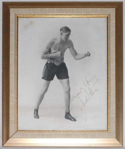 Jack Petersen. British and Empire (Commonwealth) Heavyweight Champion 1930s. Large original mono studio photograph of Peterson in boxing pose wearing his Lonsdale Belt. Nicely and boldly signed in gold ink by Peterson. Photographer&rsquo;s signature in pencil t