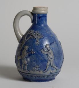 Golf jug. &lsquo;Ges Gesch&rsquo; German Blue Jug with scenes of golfers and caddies to sides. 7.5&rdquo; tall with full stamps to base. &lsquo;042&rsquo; to base. Good condition