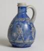 Golf jug. &lsquo;Ges Gesch&rsquo; German Blue Jug with scenes of golfers and caddies to sides. 7.5&rdquo; tall with full stamps to base. &lsquo;042&rsquo; to base. Good condition - 3