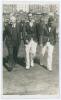 South Africa tour to England 1935. Mono real photograph postcard of South African players, Bruce Mitchell and Jock Cameron, walking off the field at Scarborough with H.D.G. Leveson-Gower, the players wearing tour blazers. Annotation in red ink to verso st