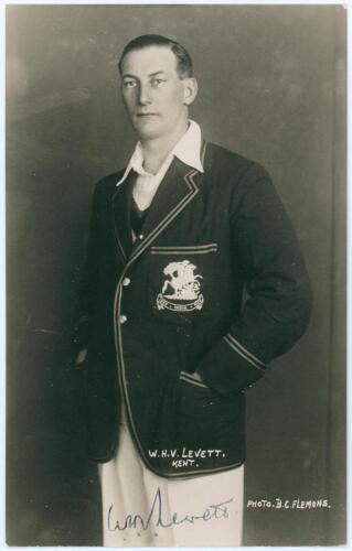 William Howard Vincent &lsquo;Hopper&rsquo; Levett. Kent & England 1930-1947. Mono real photograph studio portrait postcard of Levett standing three quarter length wearing M.C.C. blazer for the tour to India 1933/34. B.C. Flemons of Tonbridge. Signed by Levett to the