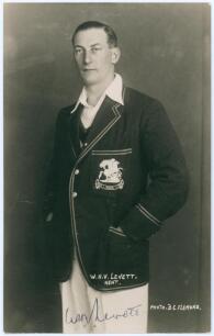 William Howard Vincent &lsquo;Hopper&rsquo; Levett. Kent & England 1930-1947. Mono real photograph studio portrait postcard of Levett standing three quarter length wearing M.C.C. blazer for the tour to India 1933/34. B.C. Flemons of Tonbridge. Signed by Levett to the