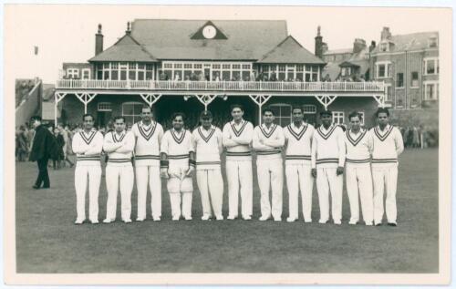 India tour to England 1952. Original mono real photograph plain back postcard of the India team lined up in one row wearing cricket attire in front of the pavilion for the tour match at Scarborough v T.N. Pearce&rsquo;s XI, 10th- 12th September 1952. Players in