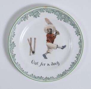 &lsquo;Out for a Duck&rsquo; Royal Doulton Black Boy tea plate, entitled &lsquo;Out for a Duck&rsquo; printed with a boy cricketer in red shirt and a floppy hat in batting pose having attempted a big shot, looking back to see the ball hit his wicket. Green floral decoration to e