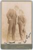 Hugh Trumble and Syd Gregory. Australia tour to England 1899. Excellent sepia cabinet card photograph of a tall Hugh Trumble looking down on Syd Gregory, both depicted full length wearing formal attire, straw boaters, and smoking cigarettes, Gregory leani