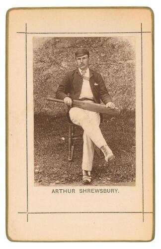 Arthur Shrewsbury. Nottinghamshire & England 1875-1902. Sepia cabinet card photograph of Shrewsbury, seated wearing cricket attire and holding a bat, with printed title below, black border surround, gilt to card edges. This same image was used as a bookpl