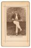 Arthur Shrewsbury. Nottinghamshire & England 1875-1902. Sepia cabinet card photograph of Shrewsbury, seated wearing cricket attire and holding a bat, with printed title below, black border surround, gilt to card edges. This same image was used as a bookpl