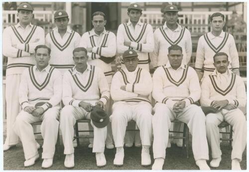 India tour to England 1936. Original mono press photograph of the All India team seated and standing in rows in front of a pavilion, wearing cricket attire. Players featured are Maharajkumar of Vizianagram (Captain), Palia, Nayudu, Nissar, Merchant, Baqa 