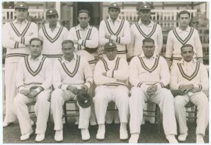 India tour to England 1936. Original mono press photograph of the All India team seated and standing in rows in front of a pavilion, wearing cricket attire. Players featured are Maharajkumar of Vizianagram (Captain), Palia, Nayudu, Nissar, Merchant, Baqa 