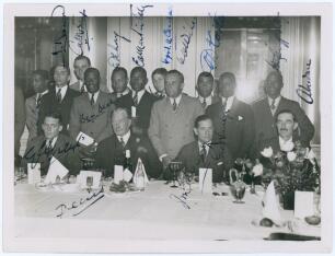 West Indies tour to England 1933. Original mono press photograph of members of the West Indies touring party attending a formal dinner. The photograph fully signed in ink by all fifteen featured players and dignitaries. Signatures are Roach, Barrow, Merry