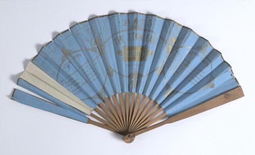 &lsquo;The Eton [and Harrow] Fan. Lord&rsquo;s 1875&rsquo;. A concertina hand fan with chromolithographic print in gold ink on a cornflower blue paper background comprising title to centre and players for both Eton and Harrow teams listed to either side within decorative b