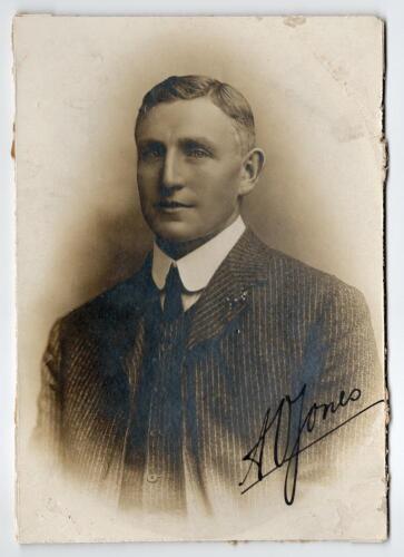 Arthur Owen Jones. Nottinghamshire & England 1892-1914. Excellent studio portrait of Jones, the M.C.C. Captain, taken on the M.C.C. tour of Australia in 1907/08. Jones is pictured wearing pin stripe suit and tie. The photograph nicely signed in black ink 