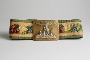 &lsquo;Cricketers under a Tree&rsquo;. Early and complete embroidered belt with oblong shaped brass belt buckle showing four cricketers standing and seated under the shelter of a tree circa 1860/70&rsquo;s. The buckle measures 2.75&rdquo;x2.25&rdquo;. The belt embroidered predominantl