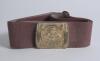 &lsquo;Cricket&rsquo;. Early and complete red material belt with excellent oblong brass belt buckle with embossed cricketer wearing boater style hat and cricket attire holding a ball with banner beneath &lsquo;Cricket&rsquo;. Cricket bat and ball decoration to each of the side 