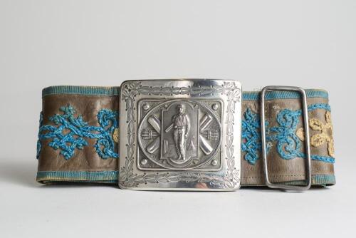 &lsquo;I.G.Jones, Dudley. May 16th 1874. 110 runs not out&rsquo;. Early and complete embroidered leather belt with magnificent oblong shaped silver belt buckle showing a batsman standing at the crease to centre with tent to background, crossed bats, stumps and cricke