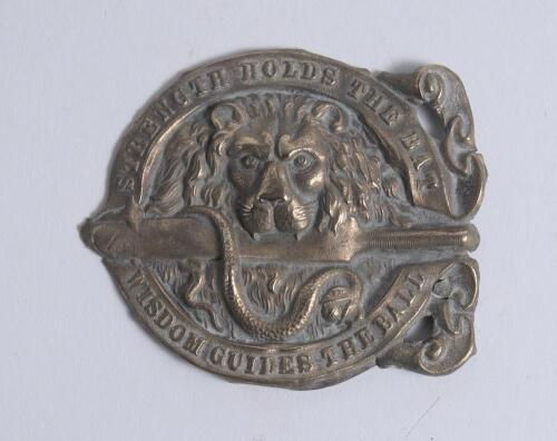 &lsquo;Strength holds the Bat, Wisdom guides the Ball&rsquo;. Early exquisite Victorian embossed circular brass belt buckle featuring a lion&rsquo;s head holding a bat in its teeth, intertwined in the design is a snake with a cricket ball between its teeth with the wording
