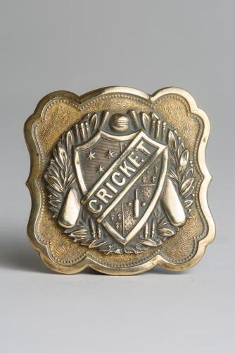 &lsquo;Cricket&rsquo;. Early and exquisite Victorian embossed square brass belt buckle, with clasp to back, decorated to centre with a winners garland, bats, ball and wickets and to the very centre with the title &lsquo;Cricket&rsquo; circa 1860/70&rsquo;s. Decorative patterned border