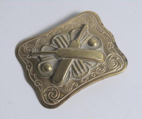 Belt buckle. Early and exquisite Victorian embossed oblong brass belt buckle, with clasp and flat hook to back, decorated to centre with crossed bats, stumps and two balls circa 1860/70&rsquo;s Decorative swirling borders. Approximately 2.5&rdquo;x2&rdquo;. Very good/excel