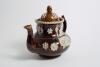 Measham Ware cricket teapot. A Victorian saltglaze stoneware brown teapot with lid. The teapot with sprigged decoration in white of two cricket figures, believed to be Pilch and Box to each side, below the figures are sprigged crossed bat and stumps with - 2