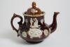 Measham Ware cricket teapot. A Victorian saltglaze stoneware brown teapot with lid. The teapot with sprigged decoration in white of two cricket figures, believed to be Pilch and Box to each side, below the figures are sprigged crossed bat and stumps with - 3