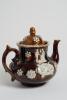 Measham Ware cricket teapot. A Victorian saltglaze stoneware brown teapot with lid. The teapot with sprigged decoration in white of two cricket figures, believed to be Pilch and Box to each side, below the figures are sprigged crossed bat and stumps with - 4