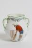 &lsquo;Good for Fifty&rsquo;. Royal Doulton Black Boy miniature two handled vase, with printed image of a boy in red shirt and a floppy hat in batting pose in front of the wicket to one side and to the other, a crest with &lsquo;The All Black Team&rsquo;. Green floral decoration