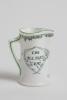 &lsquo;The Boss&rsquo;. Royal Doulton Black Boy miniature flared lip jug, with printed image of a boy in red shirt and a floppy hat, wearing an umpire&rsquo;s coat with bat to side, title to side. To verso a crest with &lsquo;The All Black Team&rsquo;. Green floral decoration to outer - 2