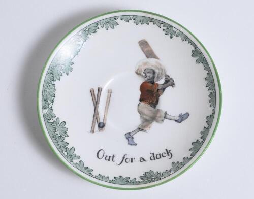 &lsquo;Out for a Duck&rsquo; Royal Doulton Black Boy saucer, entitled &lsquo;Out for a Duck&rsquo; printed with a boy in red shirt and a floppy hat in batting pose having attempted a big shot, looking back to see the ball hit his wicket. Green floral decoration to edge. 5.5&rdquo; dia