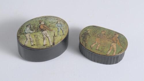Cricket snuff boxes. An oval black lacquered papier mache snuff box with hinged lid, believed to be circa 1870&rsquo;s. The lid painted with a cricketing scene of boys playing cricket with trees in background. The box measures approx 2.75&rdquo; x 2&rdquo;x .1.25&rdquo; deep. So