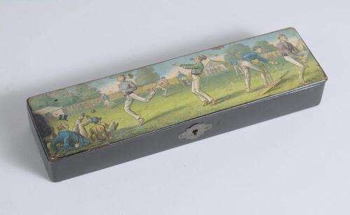 Cricket pencil case. A black lacquered papier mache oblong pencil case with hinged lid and lock to centre, believed to be circa 1870/80&rsquo;s. The lid painted with a comical cricketing scene of men playing cricket with tent and spectators to background. The c