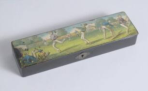 Cricket pencil case. A black lacquered papier mache oblong pencil case with hinged lid and lock to centre, believed to be circa 1870/80&rsquo;s. The lid painted with a comical cricketing scene of men playing cricket with tent and spectators to background. The c