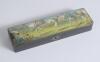 Cricket pencil case. A black lacquered papier mache oblong pencil case with hinged lid and lock to centre, believed to be circa 1870/80&rsquo;s. The lid painted with a comical cricketing scene of men playing cricket with tent and spectators to background. The c