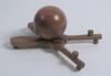 Cricket ball inkwell. An attractive Victorian wooden inkwell modelled as a cricket ball and supported by wooden crossed cricket bats with grooved pen holders and balled feet support. Approximately 6&rdquo; x 4.5&rdquo; wide. G