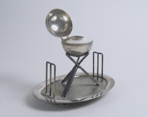 Cricket ball inkwell. An attractive Victorian silver plated inkwell modelled as a cricket ball and supported by three crossed cricket bats with two wickets, one at either end on oval base with balled feet support. The base stamped &lsquo;Holliday, Oxford, 2794&rsquo;