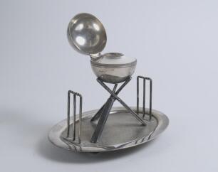 Cricket ball inkwell. An attractive Victorian silver plated inkwell modelled as a cricket ball and supported by three crossed cricket bats with two wickets, one at either end on oval base with balled feet support. The base stamped &lsquo;Holliday, Oxford, 2794&rsquo;