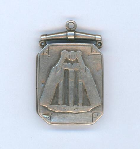 Cricket locket. Attractive oblong shaped silver opening locket with wickets, crossed bats and ball centre decoration. The reverse hallmarked. Birmingham 1887. Approximately 0.75&rdquo;x1.25&rdquo;. Some wear and the odd knock otherwise in good condition
