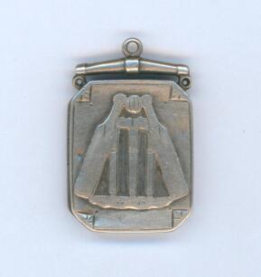 Cricket locket. Attractive oblong shaped silver opening locket with wickets, crossed bats and ball centre decoration. The reverse hallmarked. Birmingham 1887. Approximately 0.75&rdquo;x1.25&rdquo;. Some wear and the odd knock otherwise in good condition