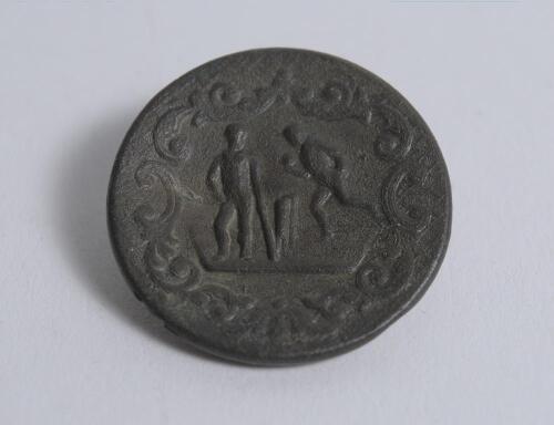 Cricket button. Very early cricket button, with figures of a batsman, under arm bowler and stumps within decorative circular border . Circa 1830/40&rsquo;s (?). Indistinct embossing to verso. G. Rare