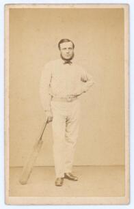 Robert Pearson Carpenter. Cambridgeshire & United England 1861-1876. Rare and early original sepia carte de visite studio photograph of Carpenter standing full length wearing cricket attire including spotted shirt, leaning on a bat. The card with printed 