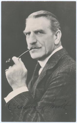 Charles Aubrey Smith. Cambridge University, Sussex, Transvaal & England 1882-1896. Mono real photograph studio portrait postcard of Smith, head and shoulders, dressed in formal suit smoking a pipe. Nicely signed in ink to darker part of the photograph by 