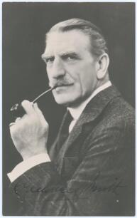 Charles Aubrey Smith. Cambridge University, Sussex, Transvaal & England 1882-1896. Mono real photograph studio portrait postcard of Smith, head and shoulders, dressed in formal suit smoking a pipe. Nicely signed in ink to darker part of the photograph by 