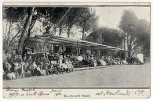 &lsquo;The Covered Stand&rsquo;. Newlands C.C. during the M.C.C. v South Africa March 1906. Mono printed postcard with large crowd in attendance during the match. Handwritten message to verso talks of the two Sussex players Hartley and Relf who are on the tour, postm