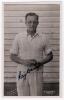 Raymond Randall &lsquo;Ray&rsquo; Dovey. Kent 1938-1954. Mono real photograph plain back postcard of Dovey standing three quarter length wearing cricket attire and holding a ball. Nicely signed in black ink to the photograph by Dovey. Printed title &lsquo;R.R. Dovey. Kent&rsquo;