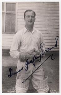Thomas Godfrey Evans. Kent & England 1939-1967. Mono real photograph plain back postcard of Evans standing three quarter length wearing wicket-keeping attire. Nicely and fully signed in black ink &lsquo;Thomas Godfrey Evans&rsquo; to the photograph. Printed title &lsquo;T.