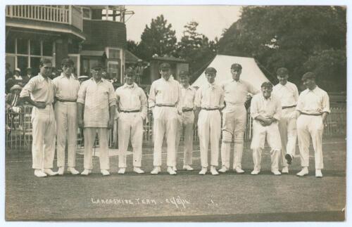 Lancashire at Bournemouth 1914. Early mono real photograph postcard of the Lancashire team standing in one row wearing cricket attire and caps, with the pavilion and spectators in the background for the match v Hampshire. Printed title to lower margin &lsquo;La