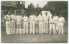 Lancashire at Bournemouth 1914. Early mono real photograph postcard of the Lancashire team standing in one row wearing cricket attire and caps, with the pavilion and spectators in the background for the match v Hampshire. Printed title to lower margin &lsquo;La