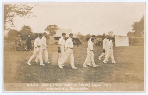 &lsquo;County Cricket Match at Hinckley August 1911, Leicestershire v Warwickshire&rsquo;. Rarer early sepia real photograph postcard of the Leicestershire team taking the field with sparse groups of spectators and marquee in the background. Printed title to lower bo